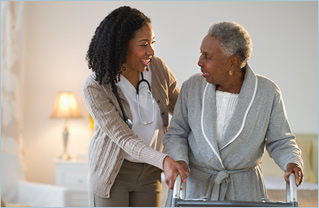 Smiling Doctor Helping Patient Walk with Walker